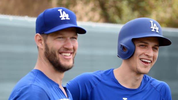 Feb 15, 2019; Glendale, AZ, USA; Los Angeles Dodgers starting pitcher Clayton Kershaw (left) and shortstop Corey Seager look on during a spring training workout at the Camelback Ranch practice fields. Mandatory Credit: Joe Camporeale-USA TODAY Sports